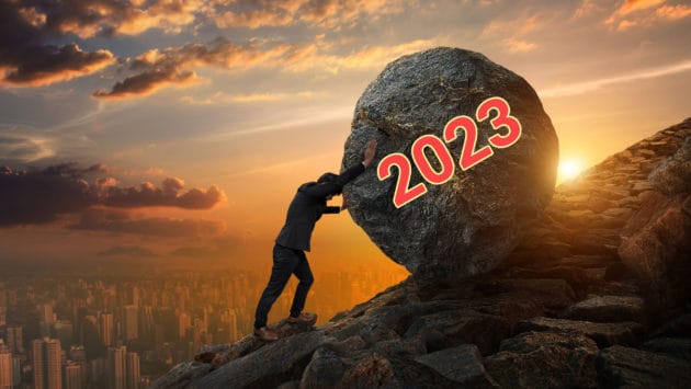 Sisyphus pushing a boulder up the hill to symbolize the challenges facing the economy in 2023.