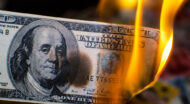An image showing a dollar bill slowly burning due to inflation eroding purchasing power.